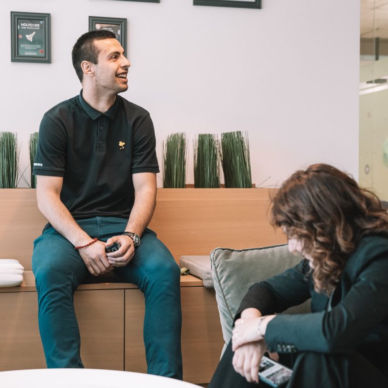 A senior software engineer laughing in an office